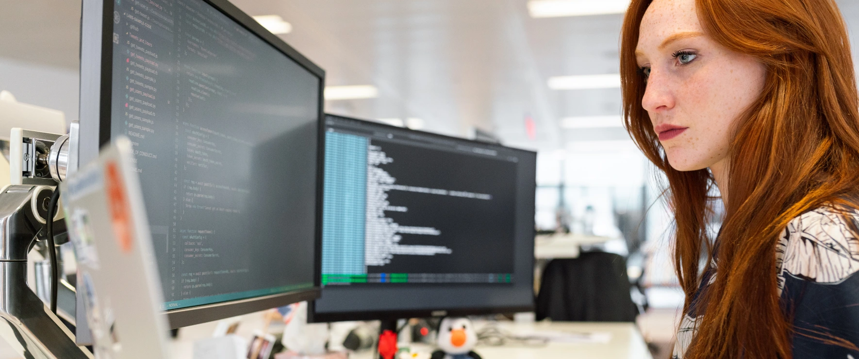 Web designer creating website layout with development code on screen