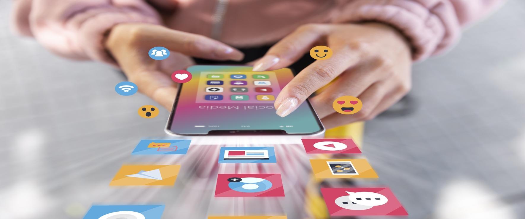 Person using a smartphone with social media marketing apps and digital interaction icons floating around.